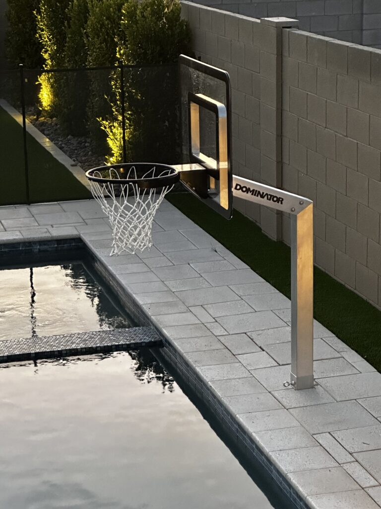 Night time swim playing basketball in the pool